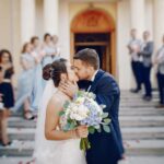 young-beautiful-bride-is-standing-near-house-with-her-husband